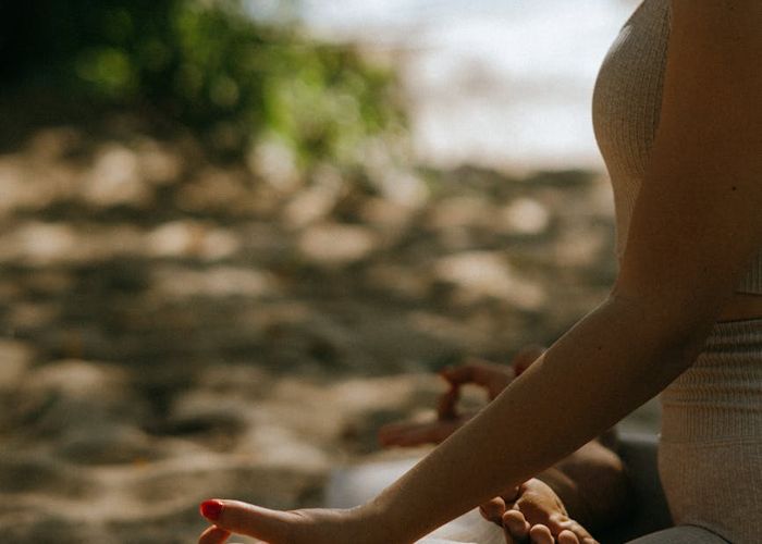 Person meditating peacefully in a softly lit environment.